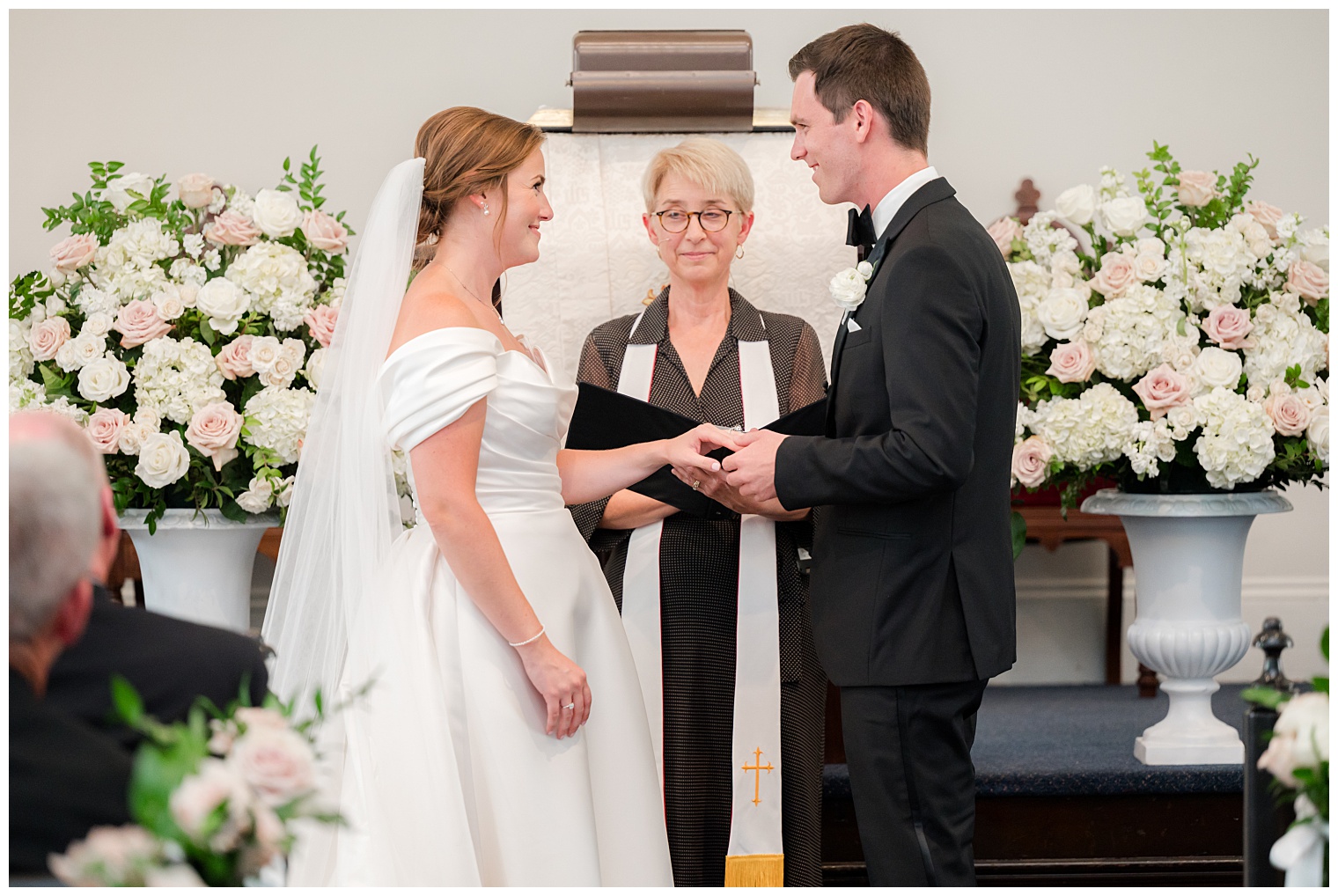 groom and bride in front of the altar