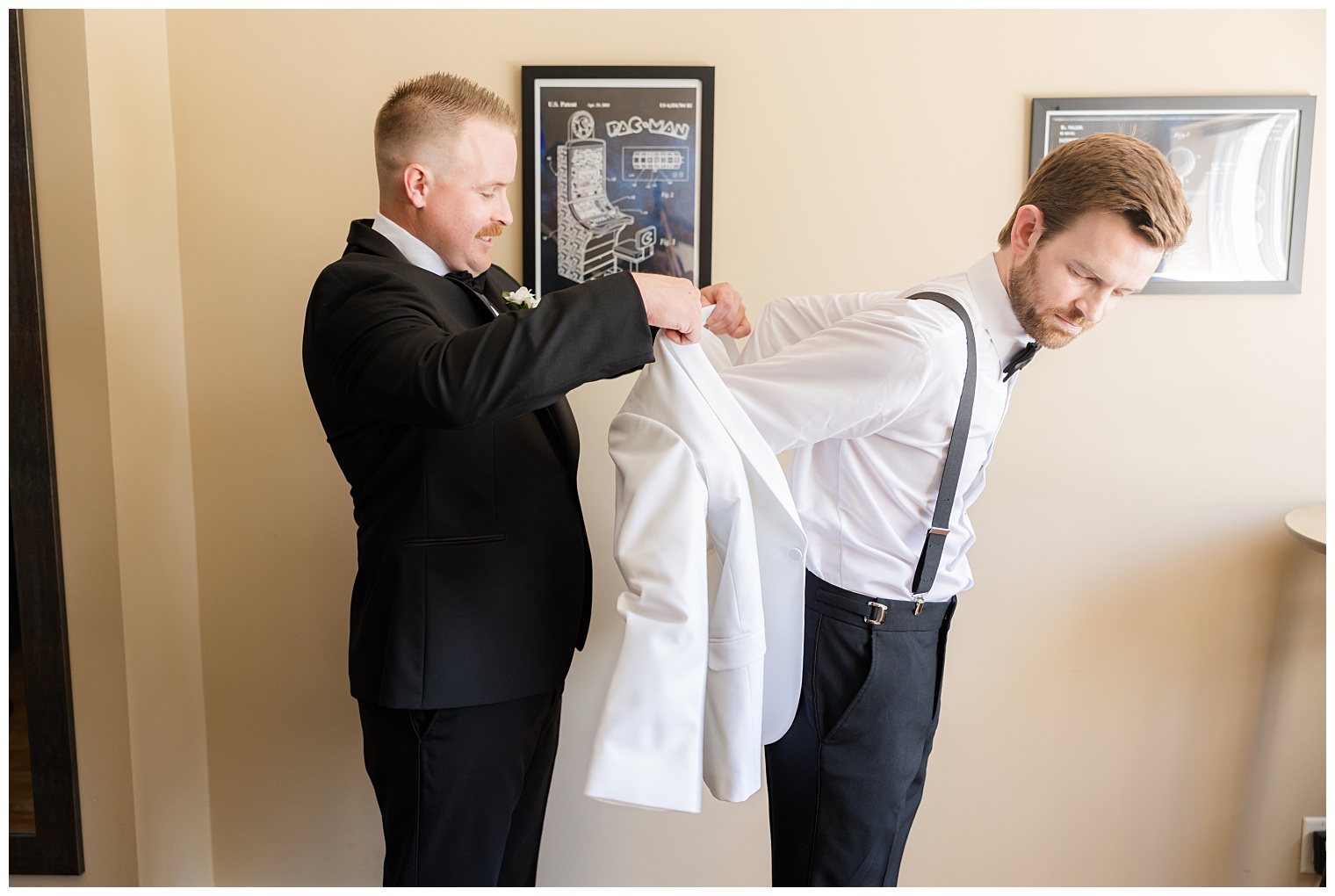 best man helping the groom get ready for the wedding