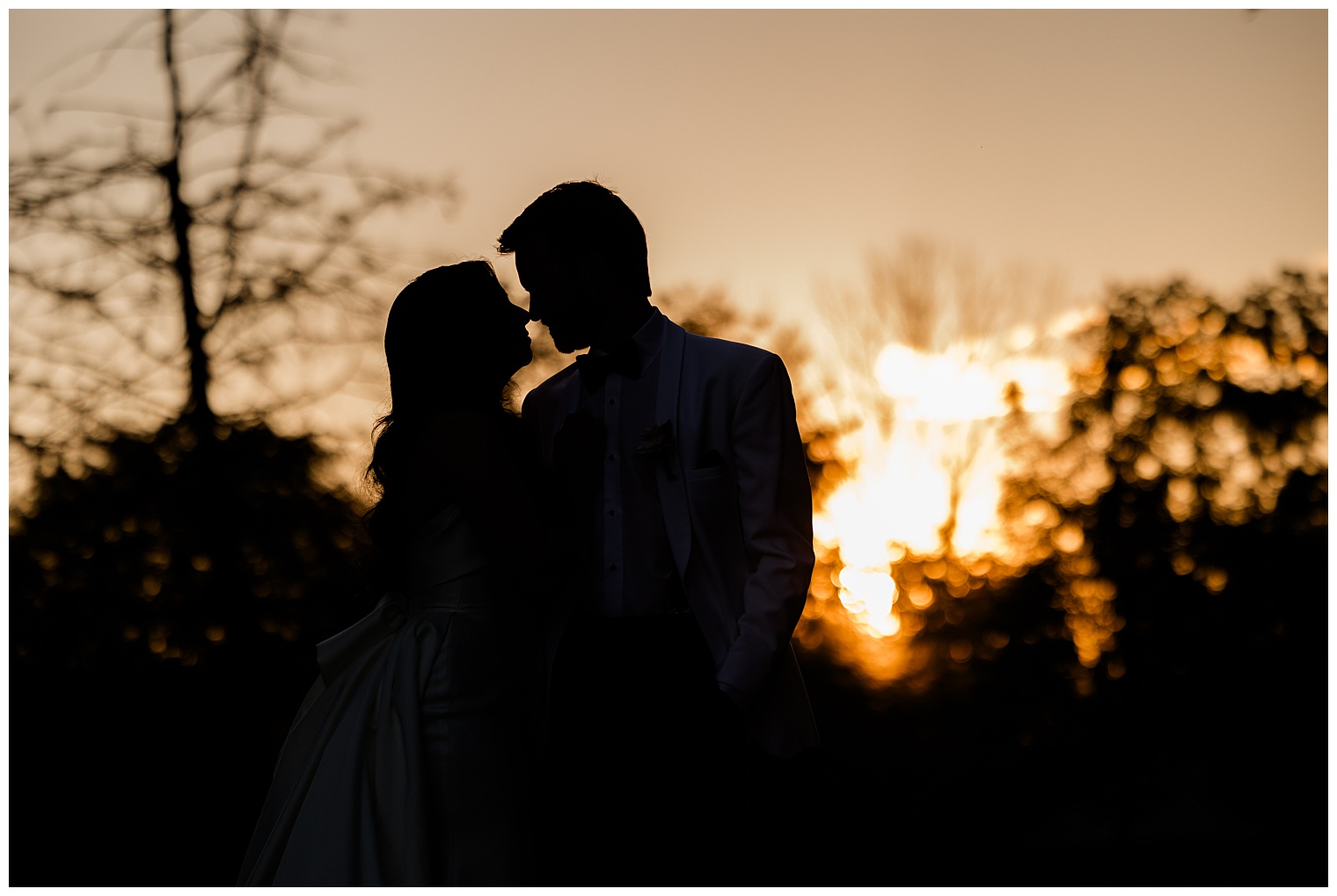 husband and wife looking at each other at sunset