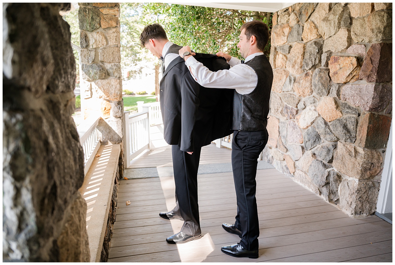 groomsman helping groom with final details