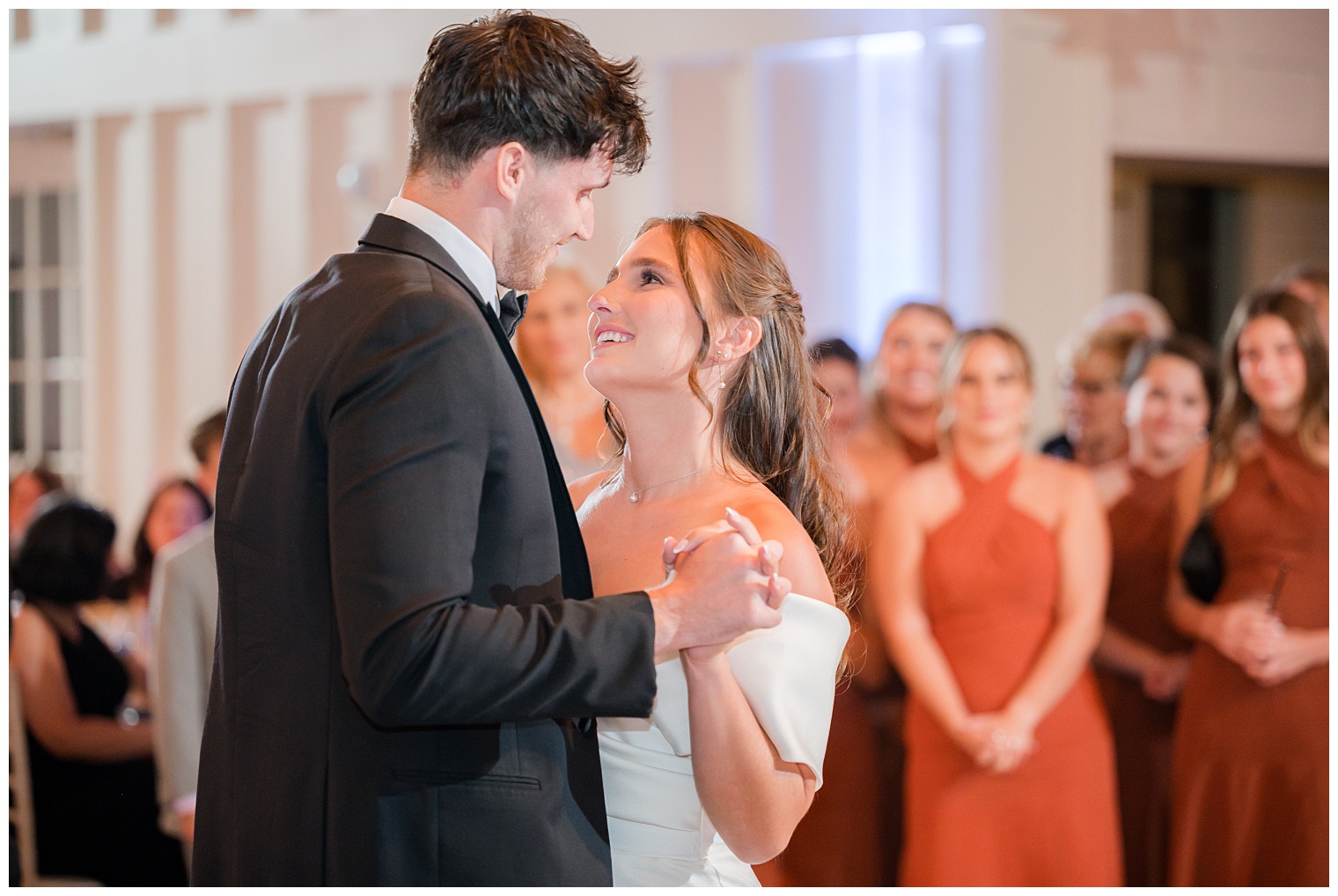 bride and groom dancing and looking at each other